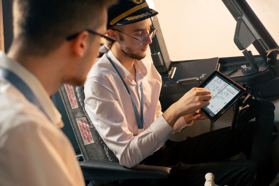 Pilots preparing a flight plan on a tablet