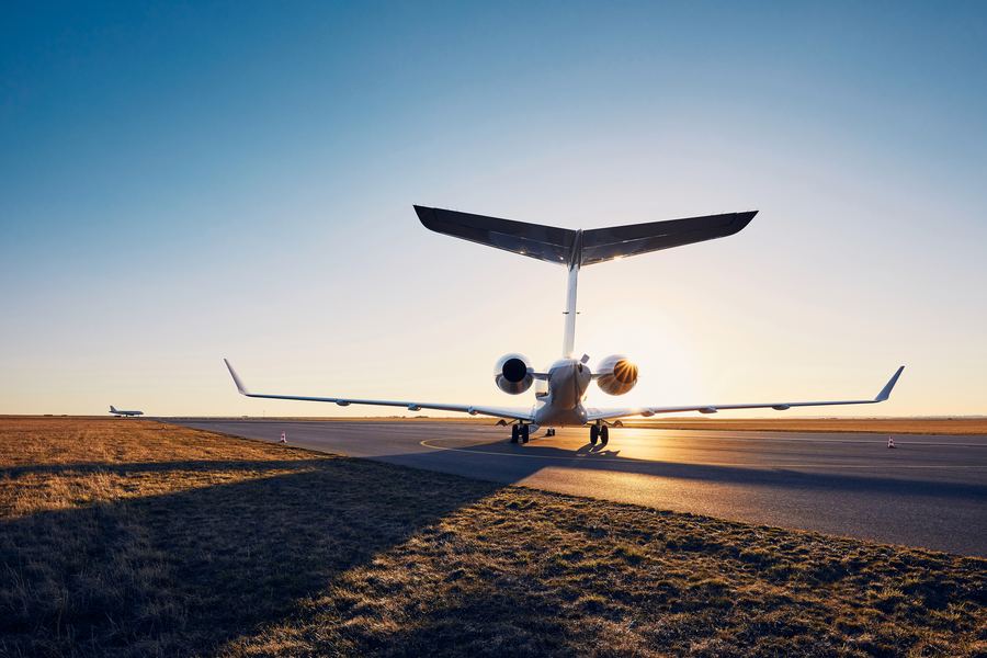 Private jet alone on an apron at sunset