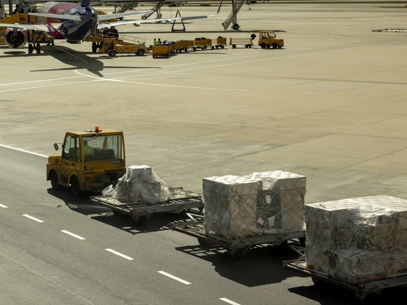 Freight pallets moving towards an aircraft