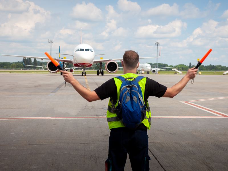 Marshaller guiding an aircraft on the apron