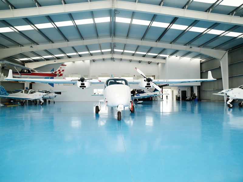 Light aircraft parked inside a hangar